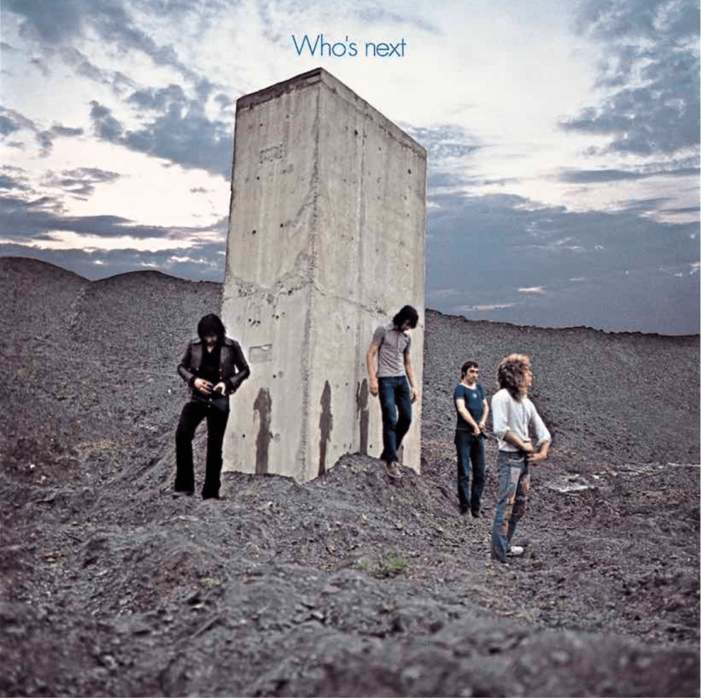 Album cover art from The Who 33rpm record  Who's Next, of the band turning their backs on a cement plinth after leaving their watery mark on it